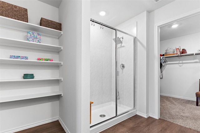516 Wrangler Dr, Josephine, TX 75189 - bathroom with a stall shower, a spacious closet, wood finished floors, and baseboards