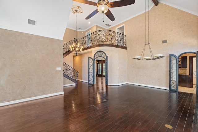 2709 Oak Point Dr, Garland, TX 75044 - unfurnished living room with arched walkways, a chandelier, a ceiling fan, wood finished floors, and high vaulted ceiling