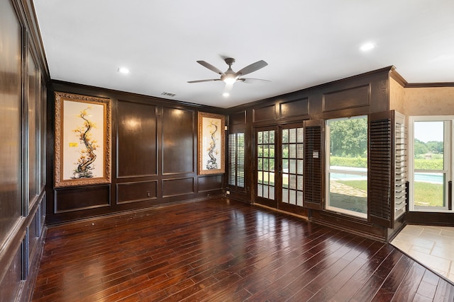 2709 Oak Point Dr, Garland, TX 75044 - unfurnished room featuring ornamental molding, french doors, a decorative wall, a ceiling fan, and wood finished floors