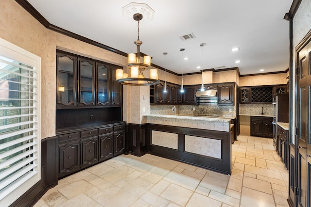 2709 Oak Point Dr, Garland, TX 75044 - kitchen with stone tile flooring, decorative backsplash, crown molding, dark brown cabinets, and a sink