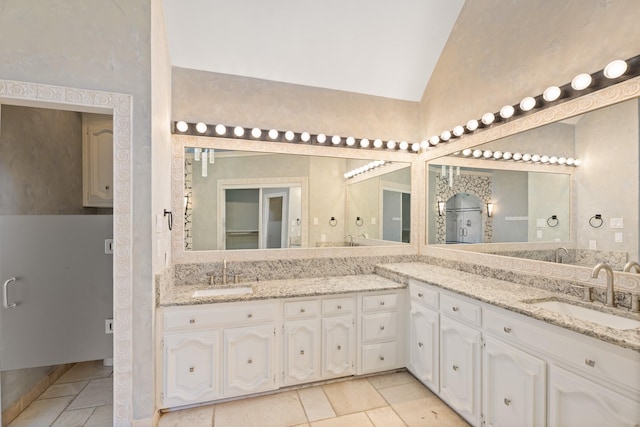 2709 Oak Point Dr, Garland, TX 75044 - bathroom featuring lofted ceiling and double vanity
