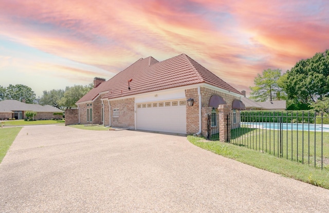 2709 Oak Point Dr, Garland, TX 75044 - view of property exterior featuring a tiled roof, concrete driveway, and an attached garage