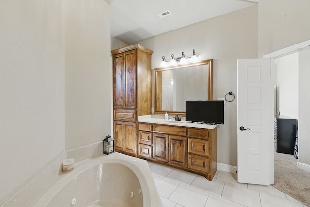 1063 Dominique Dr, Weatherford, TX 76087 - full bath with a jetted tub, vanity, tile patterned floors, and baseboards