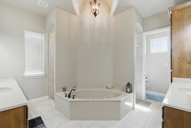 1063 Dominique Dr, Weatherford, TX 76087 - bathroom featuring vanity, a tub with jets, tile patterned flooring, and baseboards