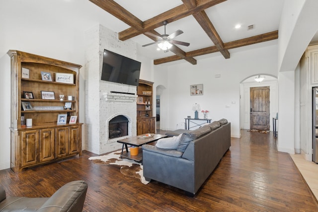 1063 Dominique Dr, Weatherford, TX 76087 - living area featuring arched walkways, coffered ceiling, a ceiling fan, beam ceiling, and wood-type flooring