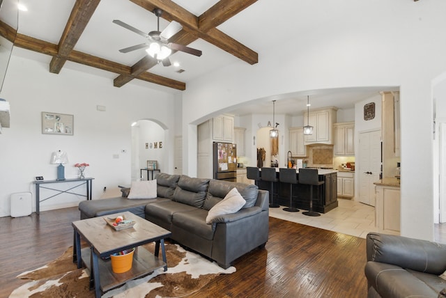 1063 Dominique Dr, Weatherford, TX 76087 - living area with arched walkways, a ceiling fan, beamed ceiling, light wood finished floors, and coffered ceiling