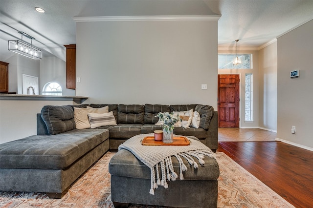 1730 Vista Ridge Dr W, Midlothian, TX 76065 - living area featuring crown molding, wood finished floors, healthy amount of natural light, baseboards, and a chandelier