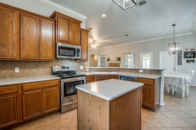 1730 Vista Ridge Dr W, Midlothian, TX 76065 - kitchen featuring stainless steel appliances, light tile patterned floors, brown cabinetry, ornamental molding, and recessed lighting