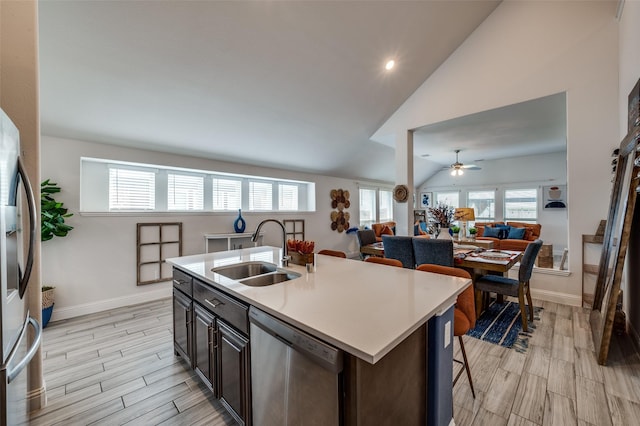 1208 Starlight Ave, Aubrey, TX 76227 - kitchen with stainless steel appliances, a sink, wood finish floors, light countertops, and a ceiling fan