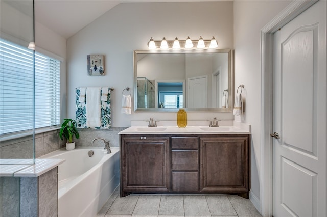 1208 Starlight Ave, Aubrey, TX 76227 - bathroom featuring a bath, lofted ceiling, double vanity, and tile patterned flooring
