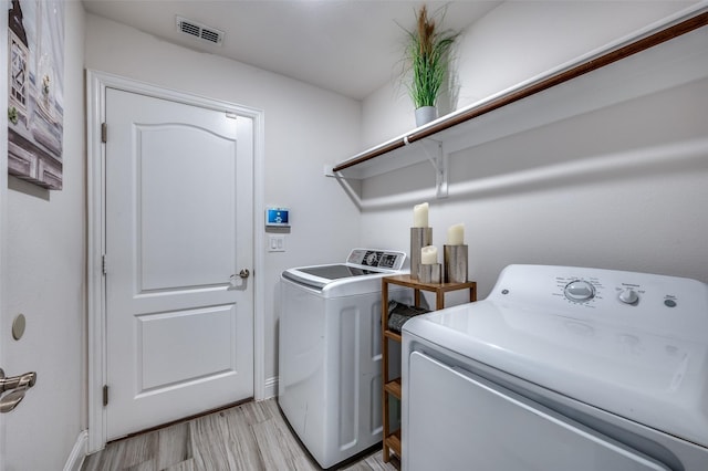 1208 Starlight Ave, Aubrey, TX 76227 - laundry room with independent washer and dryer, light wood-style floors, and baseboards
