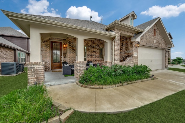 1208 Starlight Ave, Aubrey, TX 76227 - view of front of home with brick siding, a shingled roof, and cooling unit