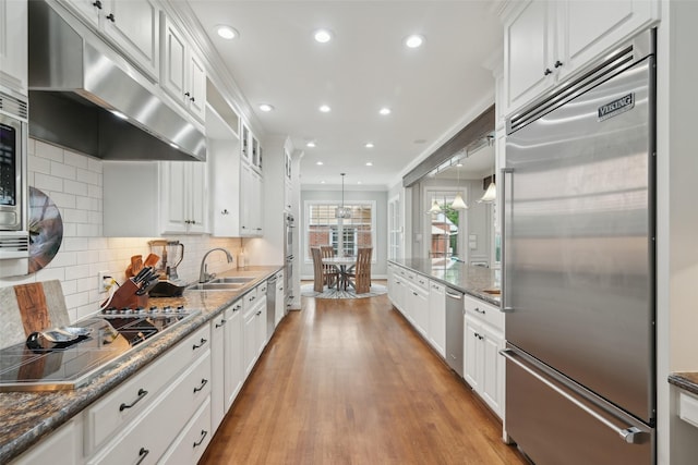 3008 Rosedale Ave, University Park, TX 75205 - kitchen featuring appliances with stainless steel finishes, ventilation hood, recessed lighting, white cabinets, and light wood finished floors