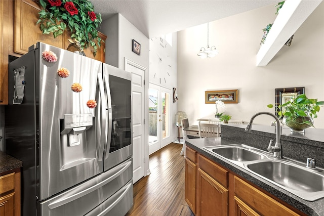 529 Mattie Ln, Lake Dallas, TX 75065 - kitchen featuring stainless steel refrigerator with ice dispenser, a sink, brown cabinets, and dark countertops