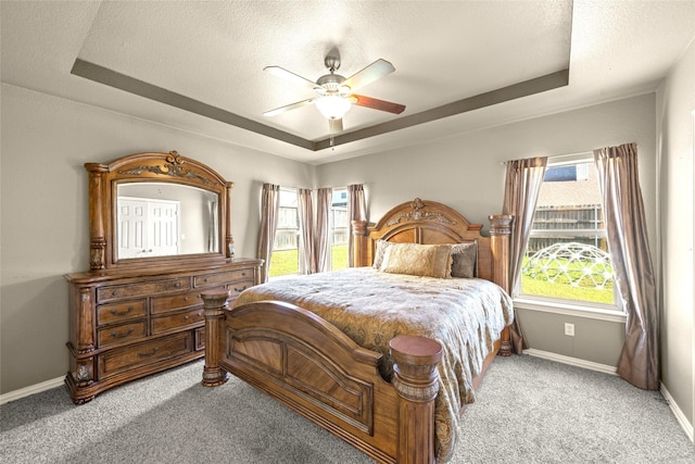 529 Mattie Ln, Lake Dallas, TX 75065 - bedroom featuring a raised ceiling, carpet, baseboards, ceiling fan, and a textured ceiling