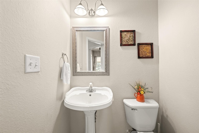 529 Mattie Ln, Lake Dallas, TX 75065 - bathroom featuring a chandelier and toilet