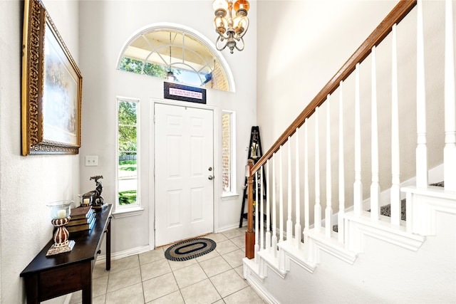 529 Mattie Ln, Lake Dallas, TX 75065 - tiled foyer with stairs, a chandelier, a towering ceiling, and baseboards
