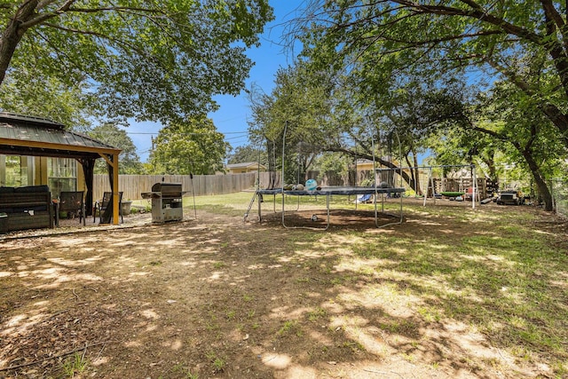 6217 Kentwood Pl, Fort Worth, TX 76112 - fenced backyard with a trampoline and a gazebo