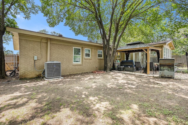 6217 Kentwood Pl, Fort Worth, TX 76112 - back of property featuring cooling unit, a gazebo, a patio, and brick siding