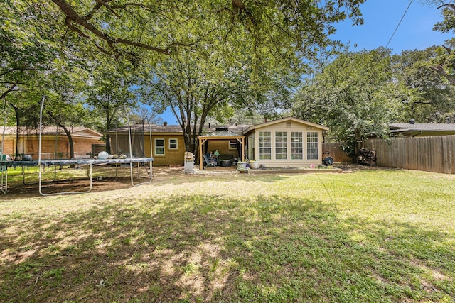 6217 Kentwood Pl, Fort Worth, TX 76112 - rear view of property with a trampoline and a sunroom