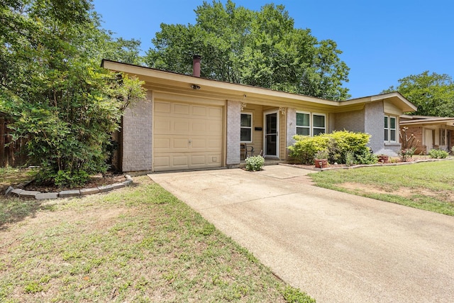 6217 Kentwood Pl, Fort Worth, TX 76112 - view of front of house with brick siding, an attached garage, concrete driveway, and a front lawn