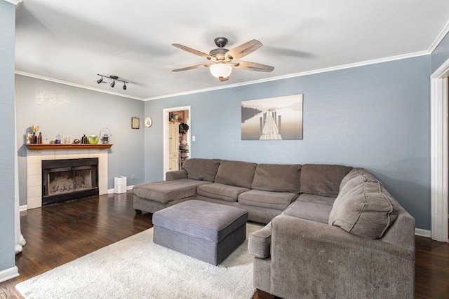 6217 Kentwood Pl, Fort Worth, TX 76112 - living room with wood finished floors, crown molding, a ceiling fan, a tiled fireplace, and rail lighting