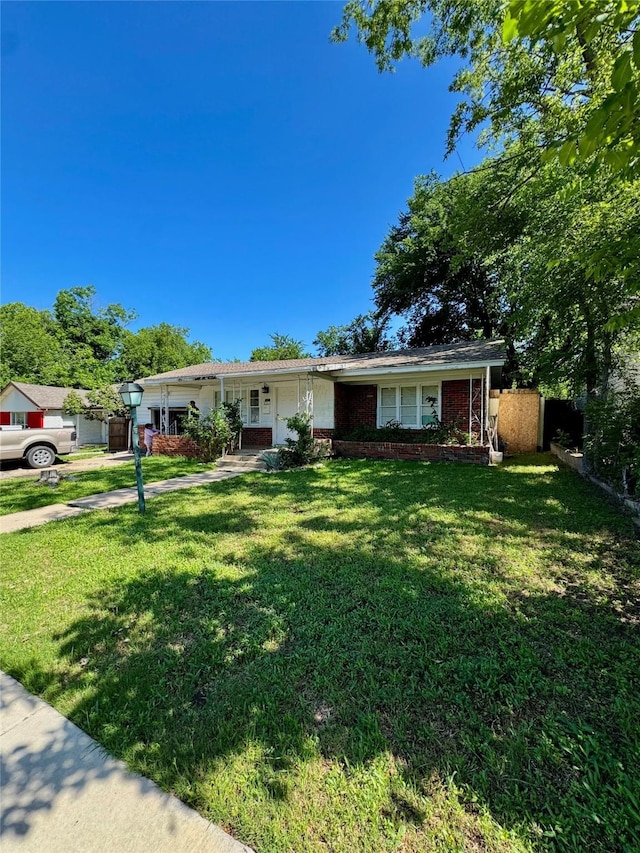 5521 Hightower St, Fort Worth, TX 76112 - ranch-style home with a front yard, brick siding, and concrete driveway