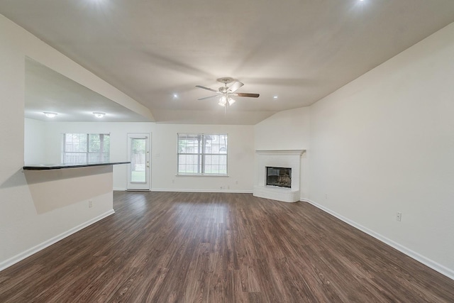 904 Havenbrook Dr, Arlington, TX 76001 - unfurnished living room with dark wood-style flooring, ceiling fan, baseboards, and plenty of natural light