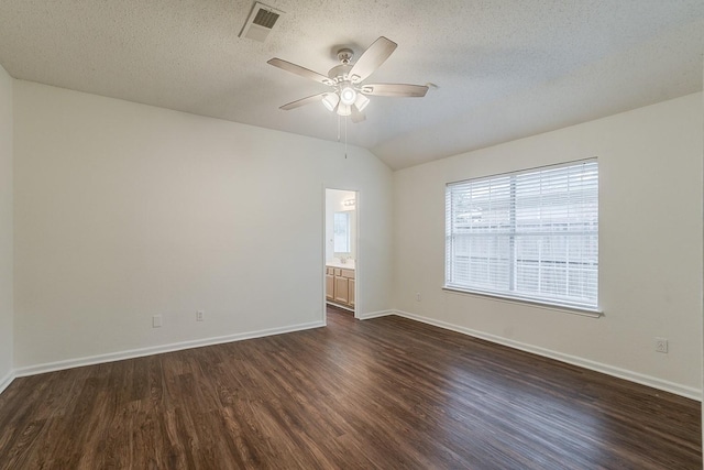904 Havenbrook Dr, Arlington, TX 76001 - empty room with dark wood-type flooring, ceiling fan, baseboards, a textured ceiling, and lofted ceiling