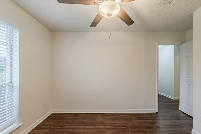 904 Havenbrook Dr, Arlington, TX 76001 - empty room featuring ceiling fan, dark wood-type flooring, healthy amount of natural light, and a textured ceiling