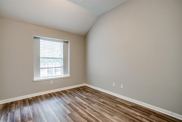 8016 Pretoria Pl, Fort Worth, TX 76123 - unfurnished room featuring dark wood finished floors, lofted ceiling, baseboards, and a textured ceiling