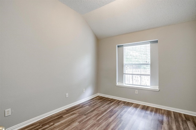 8016 Pretoria Pl, Fort Worth, TX 76123 - unfurnished room with dark wood-style flooring, baseboards, vaulted ceiling, and a textured ceiling