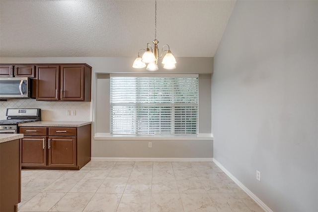 8016 Pretoria Pl, Fort Worth, TX 76123 - kitchen featuring stainless steel appliances, a chandelier, light countertops, backsplash, and hanging light fixtures