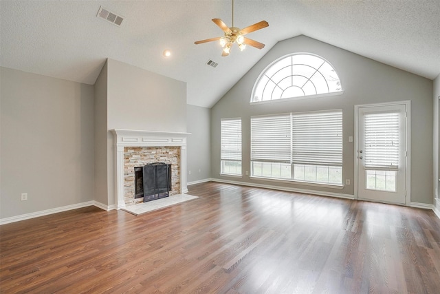 8016 Pretoria Pl, Fort Worth, TX 76123 - unfurnished living room featuring a ceiling fan, wood finished floors, a fireplace, high vaulted ceiling, and baseboards