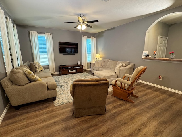 1621 Jasmine Trl, Savannah, TX 76227 - living room with arched walkways, dark wood finished floors, and a ceiling fan