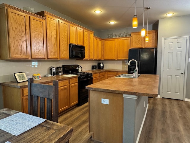 1621 Jasmine Trl, Savannah, TX 76227 - kitchen featuring black appliances, dark wood-type flooring, decorative light fixtures, a center island with sink, and recessed lighting