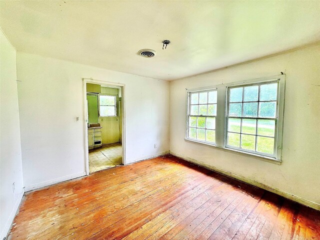 801 W State St, Groesbeck, TX 76642 - spare room featuring hardwood / wood-style flooring and baseboards