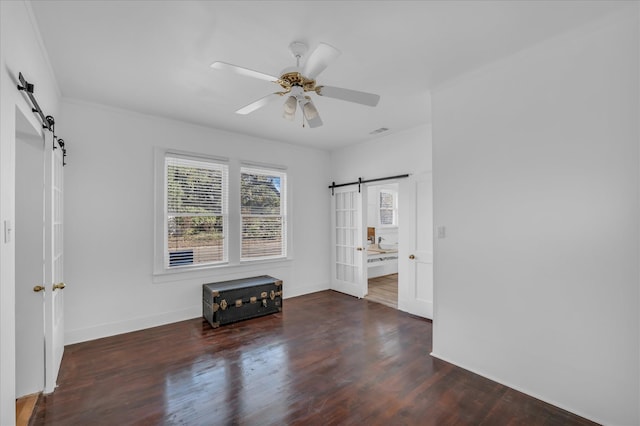 2700 Pine Ave, Waco, TX 76708 - unfurnished room featuring a barn door, wood finished floors, baseboards, and ceiling fan