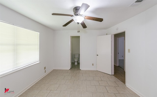 9104 Rosedown Cir, Shreveport, LA 71118 - unfurnished bedroom with light tile patterned floors, baseboards, a ceiling fan, and connected bathroom