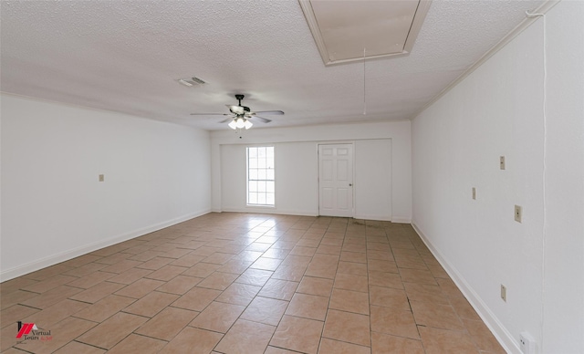 9104 Rosedown Cir, Shreveport, LA 71118 - spare room featuring attic access, a textured ceiling, ceiling fan, light tile patterned floors, and baseboards