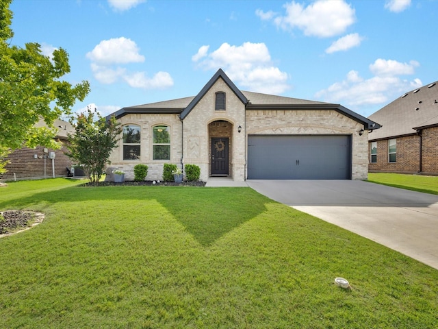 1519 Old Wichita Trl, Saginaw, TX 76131 - french country inspired facade with driveway, a garage, a front lawn, and brick siding