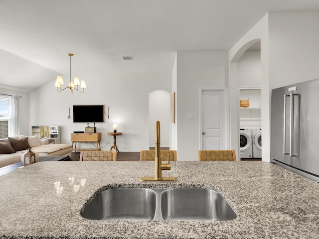 1519 Old Wichita Trl, Saginaw, TX 76131 - kitchen with a sink, washing machine and clothes dryer, open floor plan, stone countertops, and high end refrigerator