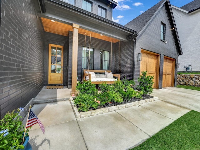 1117 Mountain View Dr, Weatherford, TX 76087 - doorway to property featuring covered porch, concrete driveway, brick siding, and an attached garage