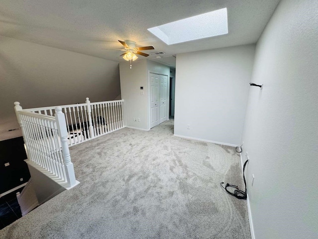 520 Timber Way Dr, Lewisville, TX 75067 - carpeted spare room with a ceiling fan, a skylight, and baseboards