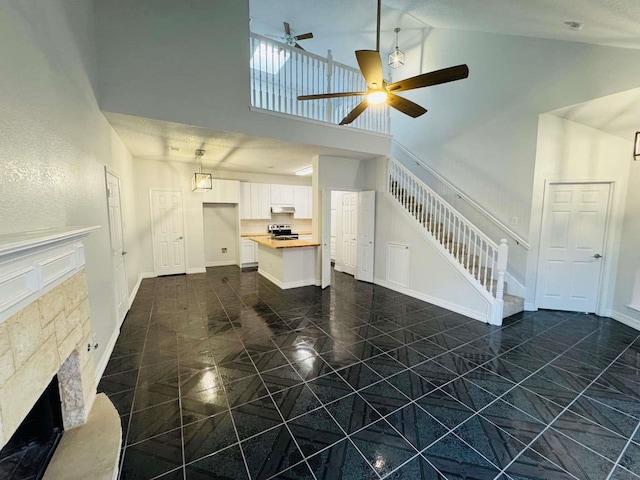 520 Timber Way Dr, Lewisville, TX 75067 - unfurnished living room with a ceiling fan, high vaulted ceiling, stairway, and baseboards