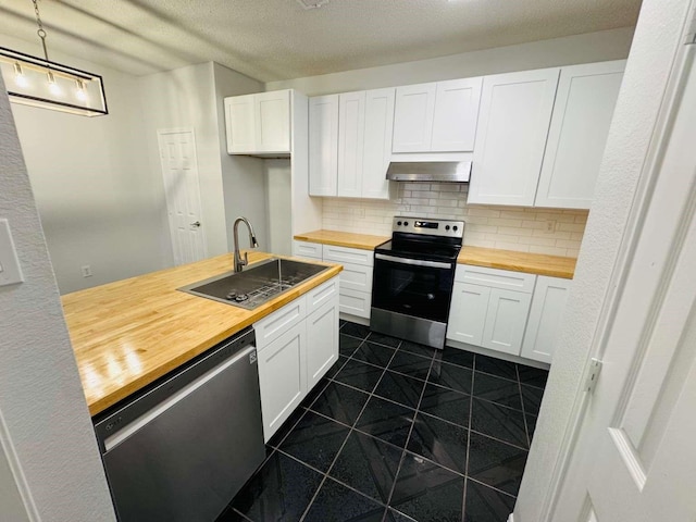 520 Timber Way Dr, Lewisville, TX 75067 - kitchen with wooden counters, stainless steel appliances, wall chimney range hood, a sink, and backsplash