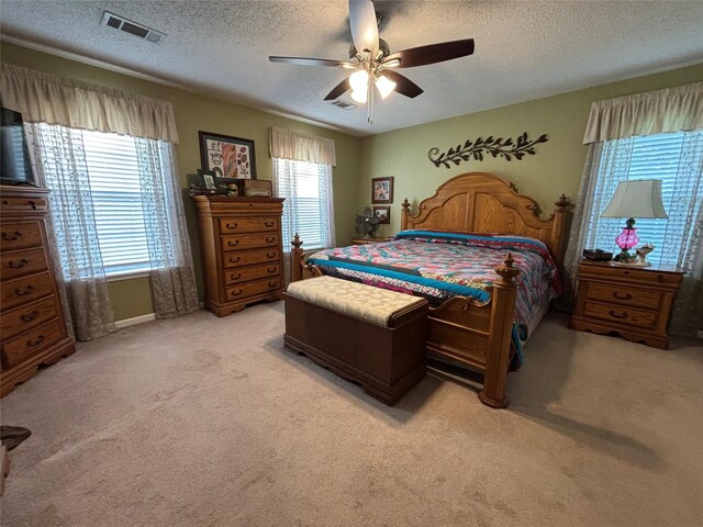 33 County Road 1131, Maud, TX 75567 - bedroom featuring light carpet, a textured ceiling, and ceiling fan