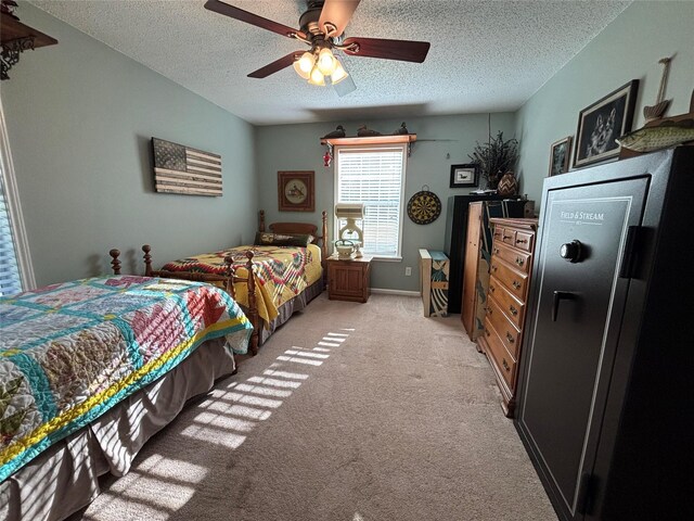 33 County Road 1131, Maud, TX 75567 - bedroom featuring a textured ceiling, light carpet, and a ceiling fan