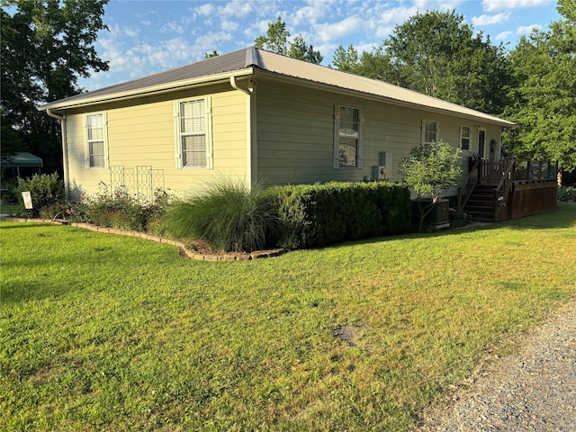 33 County Road 1131, Maud, TX 75567 - view of side of property with a lawn, a deck, metal roof, central air condition unit, and stairs