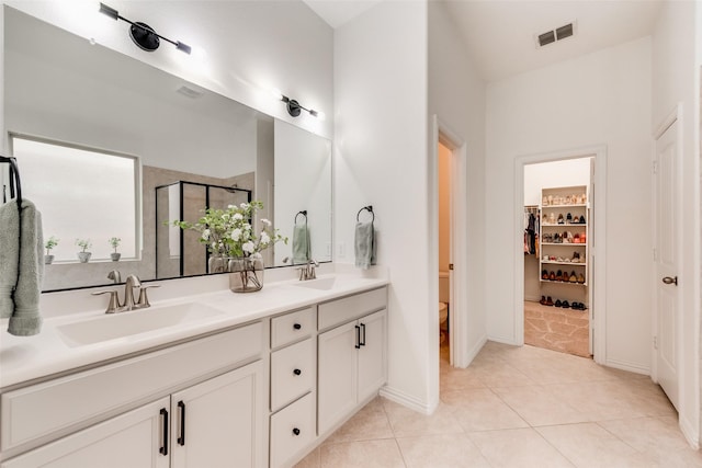 11701 Parade Dr, Frisco, TX 75036 - full bath featuring double vanity, a shower stall, tile patterned floors, a spacious closet, and toilet